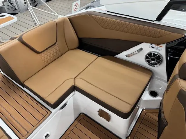 Slide: The Image of 2025 Yamaha Boats 222S interior with tan seating and wood accents. - 11