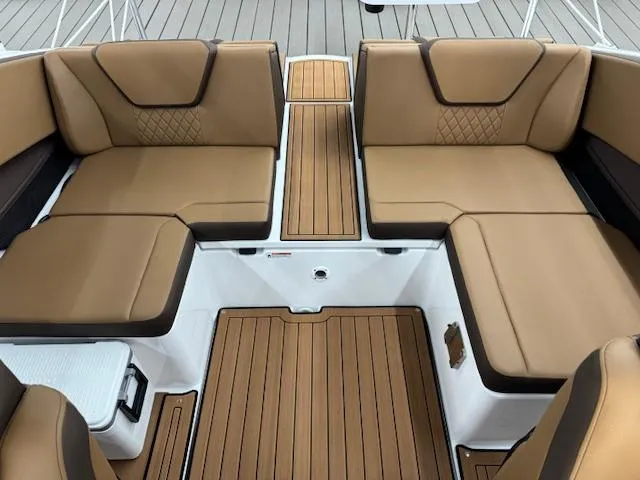 Slide: The Image of 2025 Yamaha Boats 222S interior with tan seating and teak-style flooring. - 12