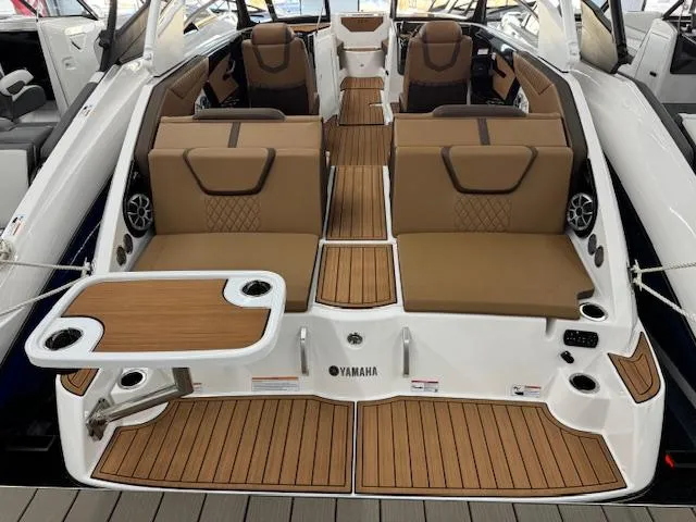 Slide: The Image of 2025 Yamaha Boats 222S interior with brown seating and wood accents. - 17