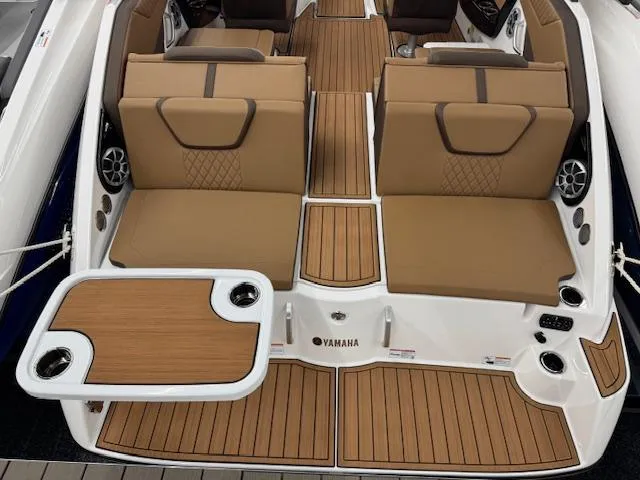 Slide: The Image of 2025 Yamaha Boats 222S interior with tan seating and wood-style flooring. - 18