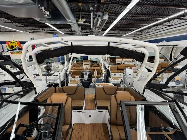 Slide: The Image of 2025 Yamaha Boats 222S interior, showcasing luxurious seating and modern design in a showroom setting. - 4