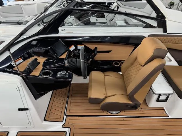 Slide: The Image of 2025 Yamaha Boats 222S interior with tan seating and sleek dashboard design. - 5