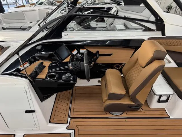 Slide: The Image of 2025 Yamaha Boats 222S cockpit with tan seating and modern dashboard. - 6