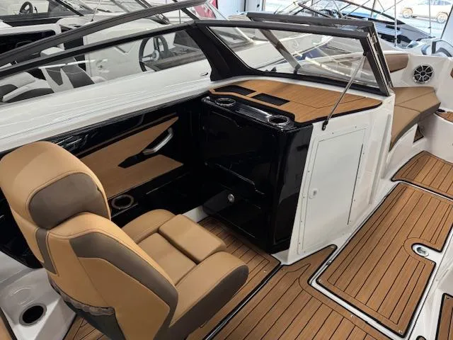 Slide: The Image of 2025 Yamaha Boats 222S interior with tan seating and sleek dashboard design. - 8