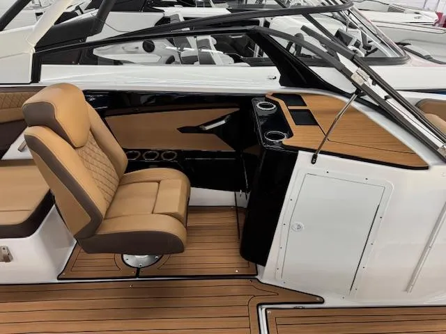 Slide: The Image of 2025 Yamaha Boats 222S interior with tan seating and wood accents. - 9