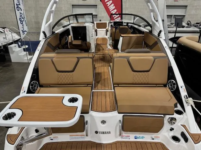 Slide: The Image of 2025 Yamaha Boats 252SE interior with tan seating and wood accents. - 1
