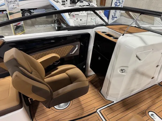 Slide: The Image of 2025 Yamaha Boats 252SE interior with tan seating and wood-style flooring. - 10