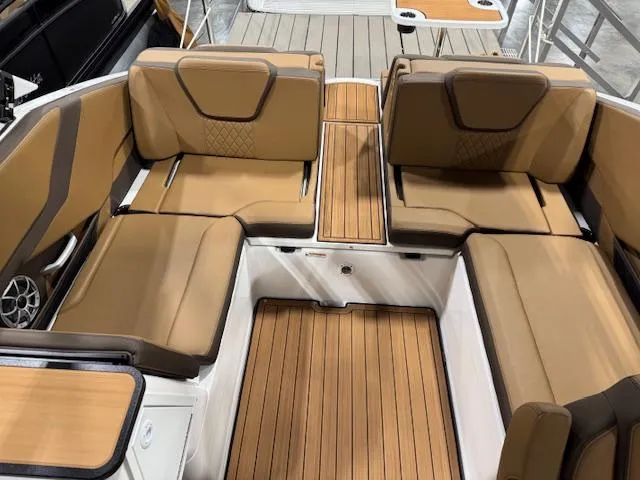Slide: The Image of 2025 Yamaha Boats 252SE interior with tan seating and wood-style flooring. - 11