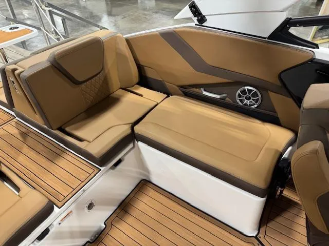 Slide: The Image of 2025 Yamaha Boats 252SE interior with tan seating and wood flooring. - 12