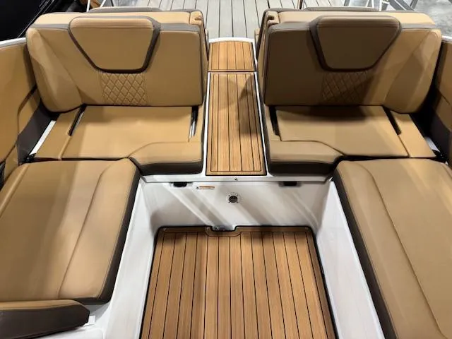 Slide: The Image of 2025 Yamaha Boats 252SE interior with tan seating and wood-style flooring. - 13