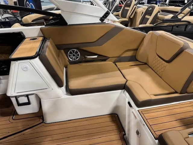 Slide: The Image of 2025 Yamaha Boats 252SE interior with tan seating and wood accents. - 14