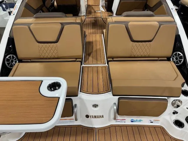 Slide: The Image of 2025 Yamaha Boats 252SE interior with tan seating and wood accents. - 19