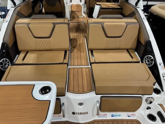 Slide: The Image of 2025 Yamaha Boats 252SE interior with tan seating and wood accents. - 20