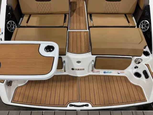 Slide: The Image of 2025 Yamaha Boats 252SE interior with teak flooring and tan seating. - 21