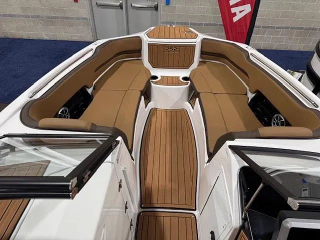 Slide: The Image of 2025 Yamaha Boats 252SE interior with tan seating and wood-style flooring. - 3