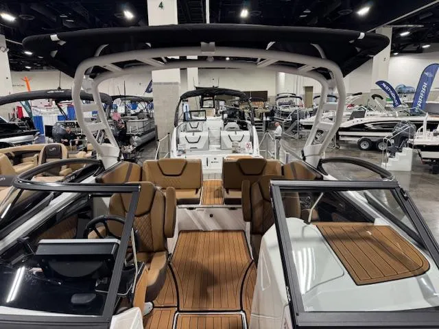Slide: The Image of 2025 Yamaha Boats 252SE interior at a boat show, featuring sleek design and modern amenities. - 5