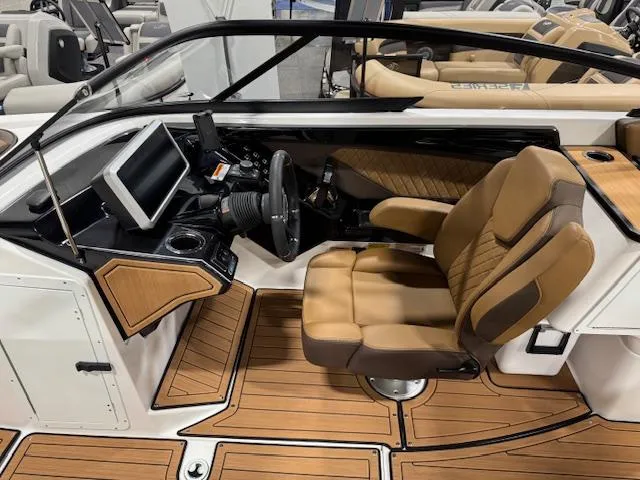 Slide: The Image of 2025 Yamaha Boats 252SE interior with tan seating and modern dashboard. - 6