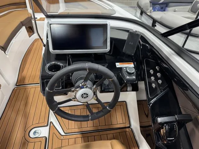 Slide: The Image of 2025 Yamaha Boats 252SE dashboard with steering wheel and touchscreen display. - 7