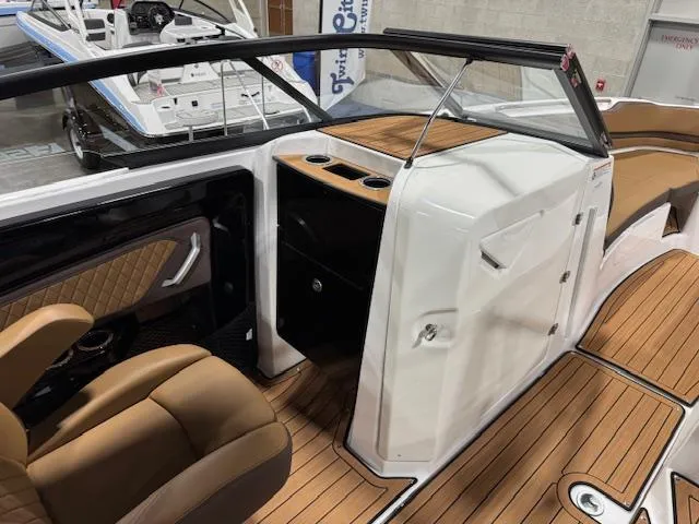 Slide: The Image of 2025 Yamaha Boats 252SE interior with brown seating and wood accents. - 8