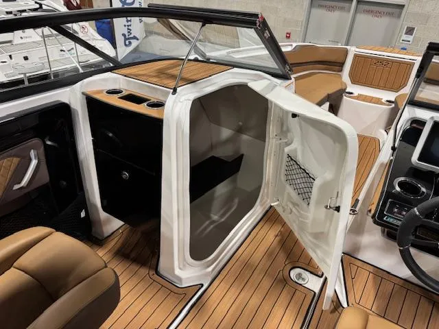 Slide: The Image of 2025 Yamaha Boats 252SE interior with open storage compartment and elegant wood finish. - 9