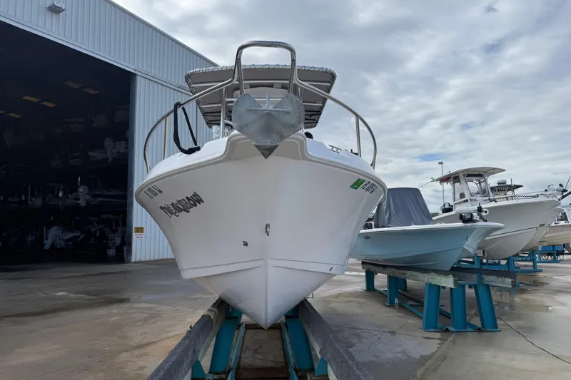 The Image of 2006 Pro-Line 21 Sport boat on dry dock, front view, overcast sky. - 0