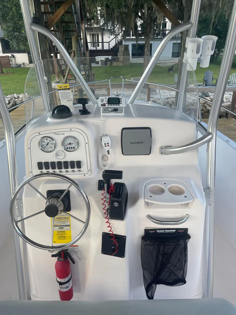 Slide: The Image of 2006 Pro-Line 21 Sport boat console with steering wheel, gauges, and Garmin GPS. - 14