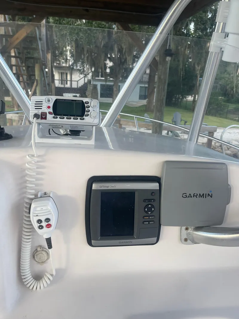 Slide: The Image of 2006 Pro-Line 21 Sport boat dashboard with Garmin navigation system and radio equipment. - 3