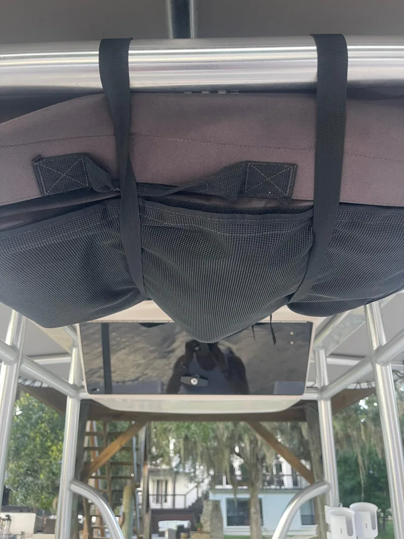 Slide: The Image of 2006 Pro-Line 21 Sport boat with overhead storage and secure netting. - 8