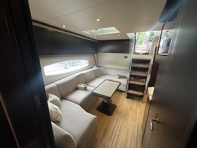 Slide: The Image of Luxurious interior of 2017 Regal 53 Sport Coupe yacht with modern seating and wooden flooring. - 14