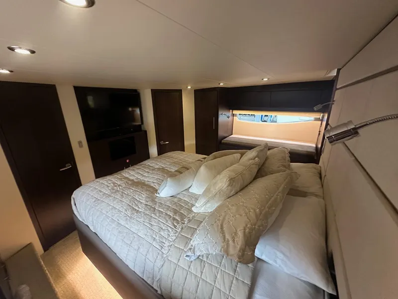 Slide: The Image of Luxurious bedroom interior of 2017 Regal 53 Sport Coupe yacht with elegant bedding and modern lighting. - 23