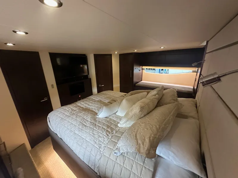 Slide: The Image of Luxurious bedroom interior of 2017 Regal 53 Sport Coupe yacht with cozy bedding and modern decor. - 24