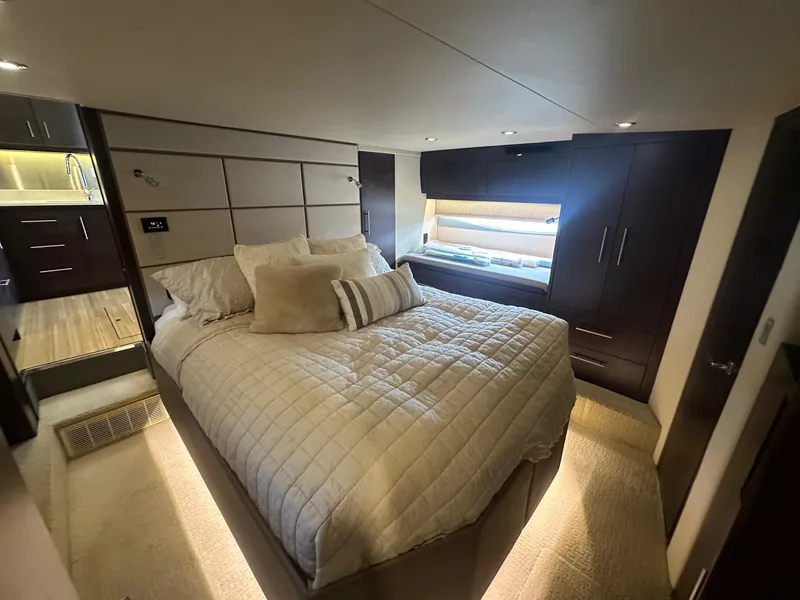 Slide: The Image of Luxurious bedroom interior of 2017 Regal 53 Sport Coupe yacht, featuring elegant bedding and modern design. - 27