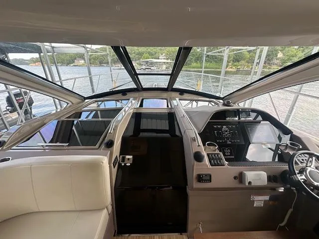 Slide: The Image of Interior view of 2017 Regal 53 Sport Coupe yacht cockpit with panoramic windows. - 31