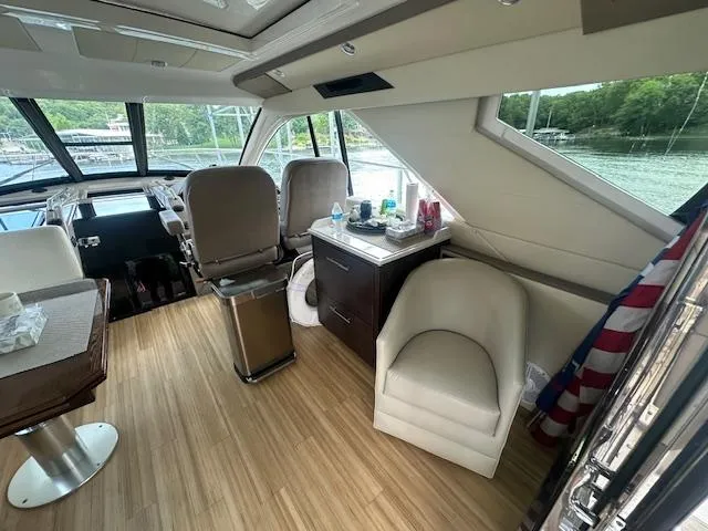 Slide: The Image of Interior of 2017 Regal 53 Sport Coupe yacht with seating and helm, featuring modern design. - 35