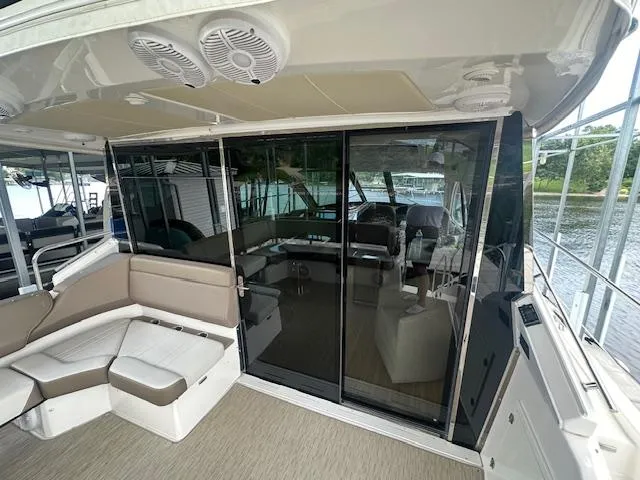 Slide: The Image of 2017 Regal 53 Sport Coupe yacht interior with sleek seating and glass doors. - 38
