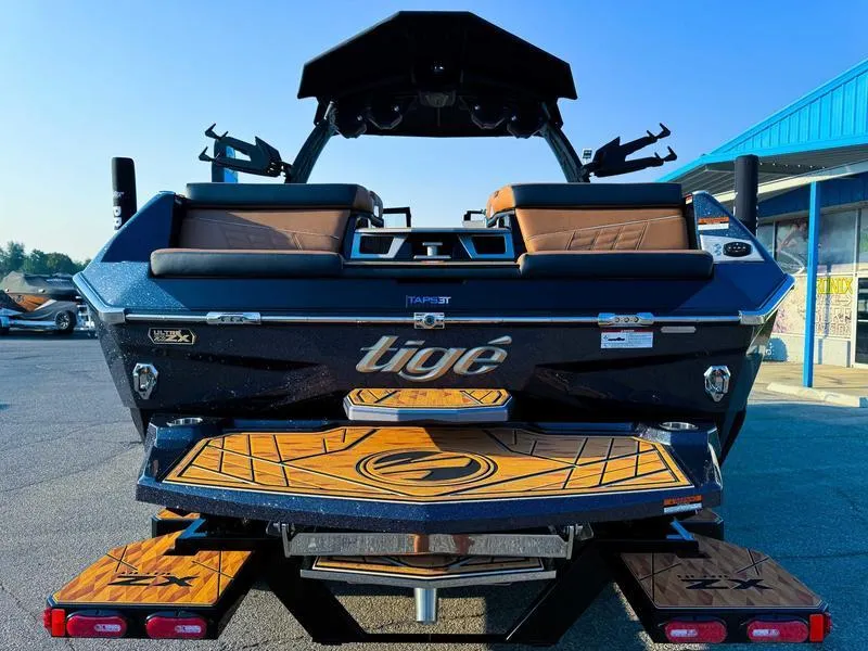 Slide: The Image of 2025 Tigé ULTRE 23ZX boat rear view with teak deck and sleek design. - 10