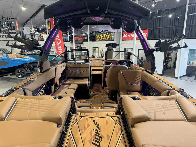 Slide: The Image of 2025 Tigé ULTRE 23ZX boat interior with luxurious seating and modern design in showroom. - 11