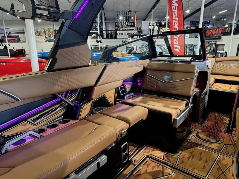Slide: The Image of 2025 Tigé ULTRE 23ZX boat interior with luxurious brown seating and modern design. - 12