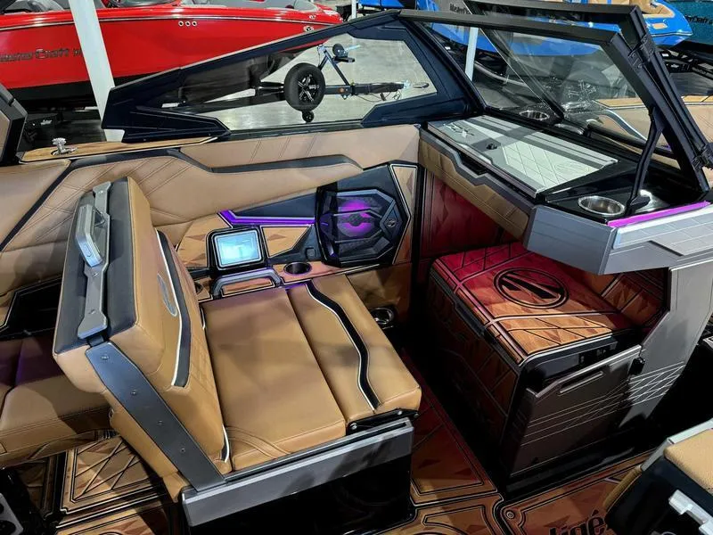 Slide: The Image of 2025 Tigé ULTRE 23ZX boat interior with modern dashboard and luxurious seating. - 13