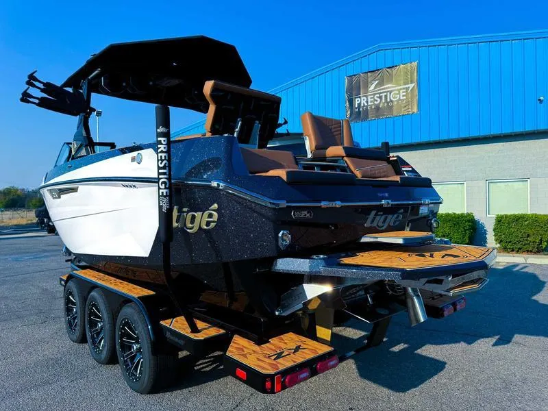 Slide: The Image of 2025 Tigé ULTRE 23ZX boat on trailer, parked outside Prestige building. - 6