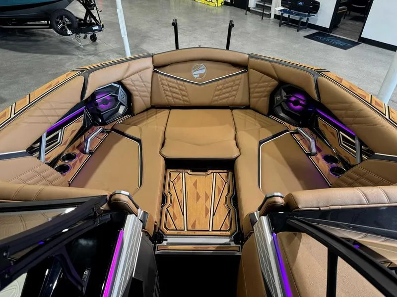 Slide: The Image of 2025 Tigé ULTRE 23ZX boat interior with luxurious tan seating and purple LED lighting. - 7