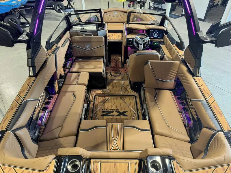 Slide: The Image of 2025 Tigé ULTRE 23ZX boat interior with luxurious tan seating and modern dashboard. - 8