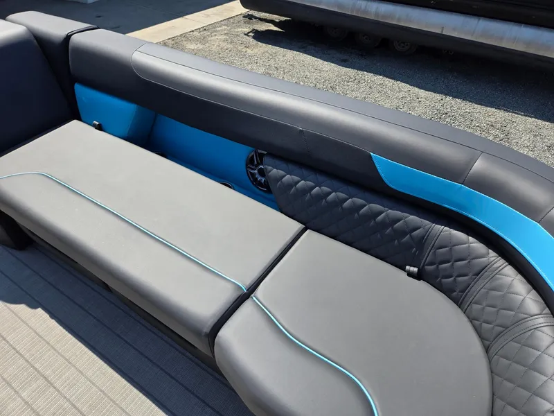 Slide: The Image of 2025 Godfrey Sweetwater 2486 SB boat seating with sleek gray and blue upholstery. - 12