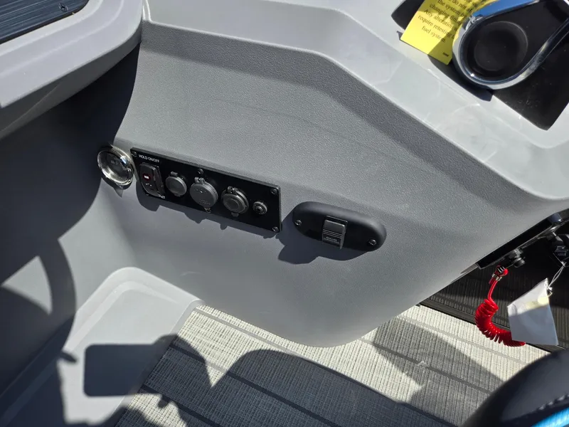 Slide: The Image of 2025 Godfrey Sweetwater 2486 SB boat dashboard with control panel and switches. - 20