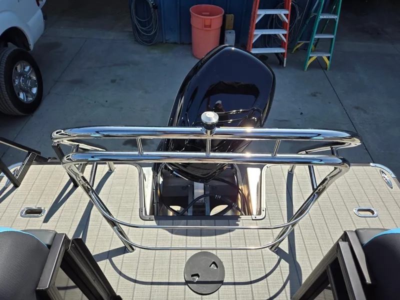 Slide: The Image of 2025 Godfrey Sweetwater 2486 SB boat deck with sleek railing and motor. - 25