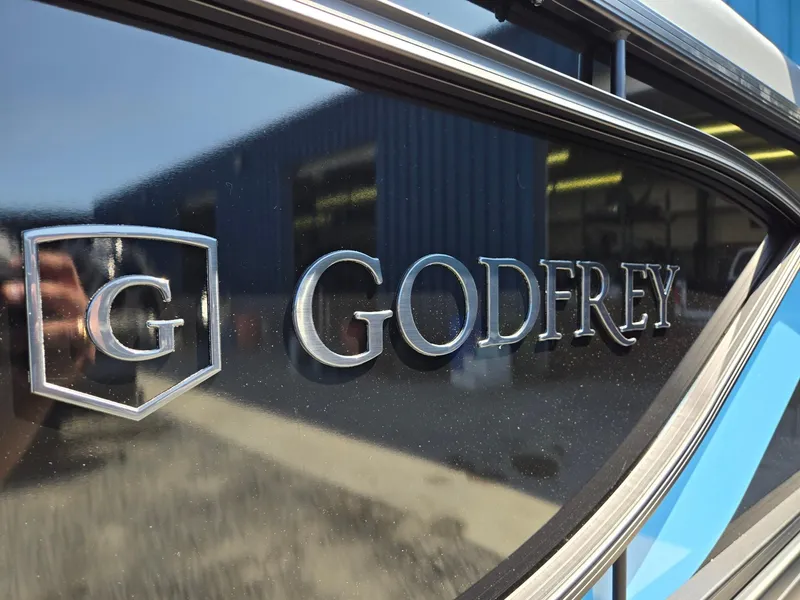 Slide: The Image of Close-up of 2025 Godfrey Sweetwater 2486 SB logo on boat exterior. - 38