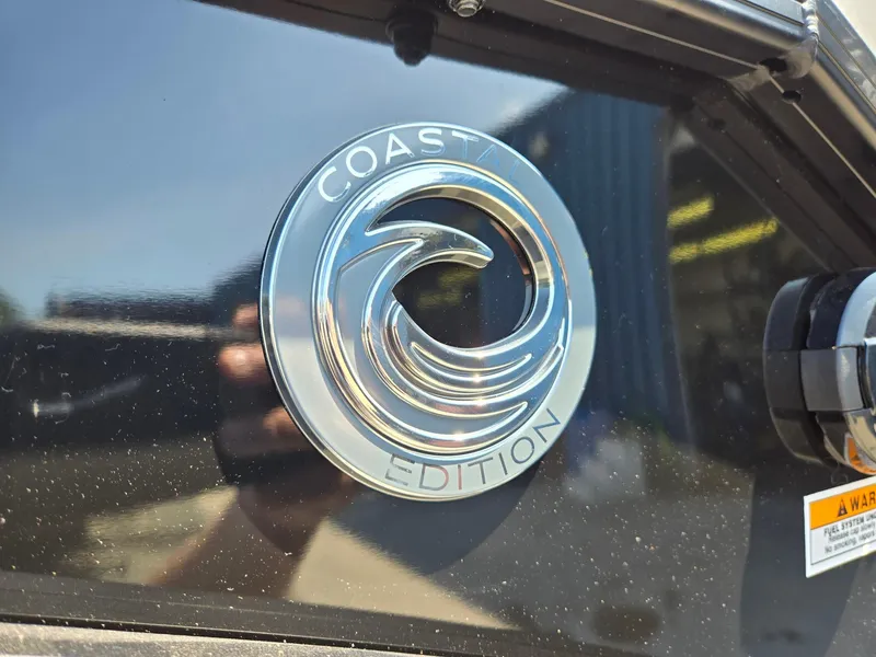 Slide: The Image of 2025 Godfrey Sweetwater 2486 SB Coast Edition emblem on black surface. - 39