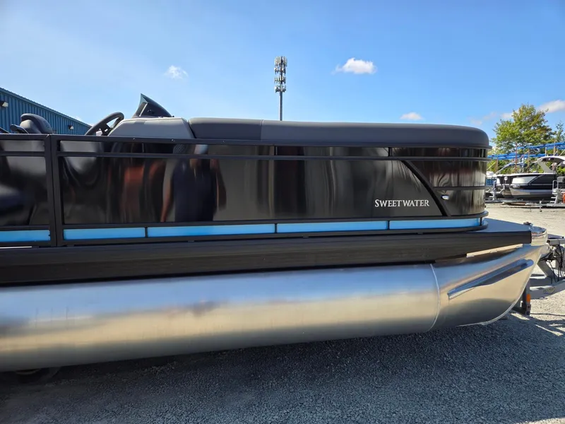 Slide: The Image of 2025 Godfrey Sweetwater 2486 SB pontoon boat, side view, parked on gravel. - 7