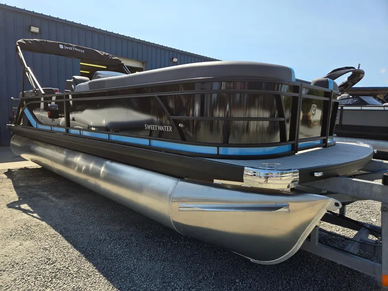 Slide: The Image of 2025 Godfrey Sweetwater 2486 SB pontoon boat on trailer, parked outdoors. - 8
