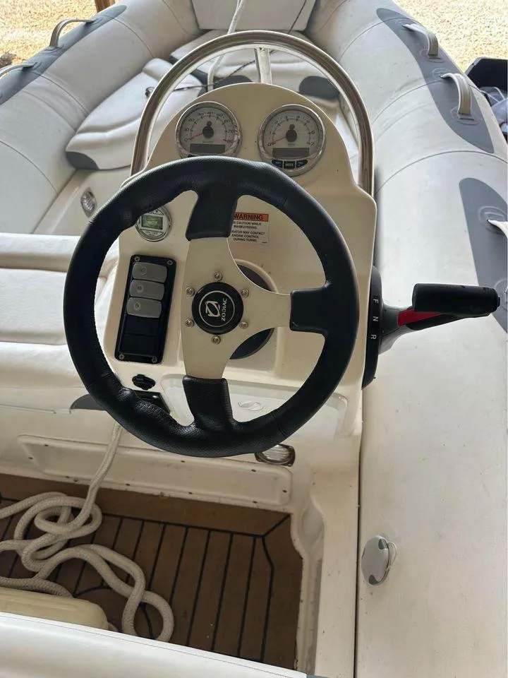 Slide: The Image of 2021 Zodiac 440DL boat steering console with gauges and controls. - 3